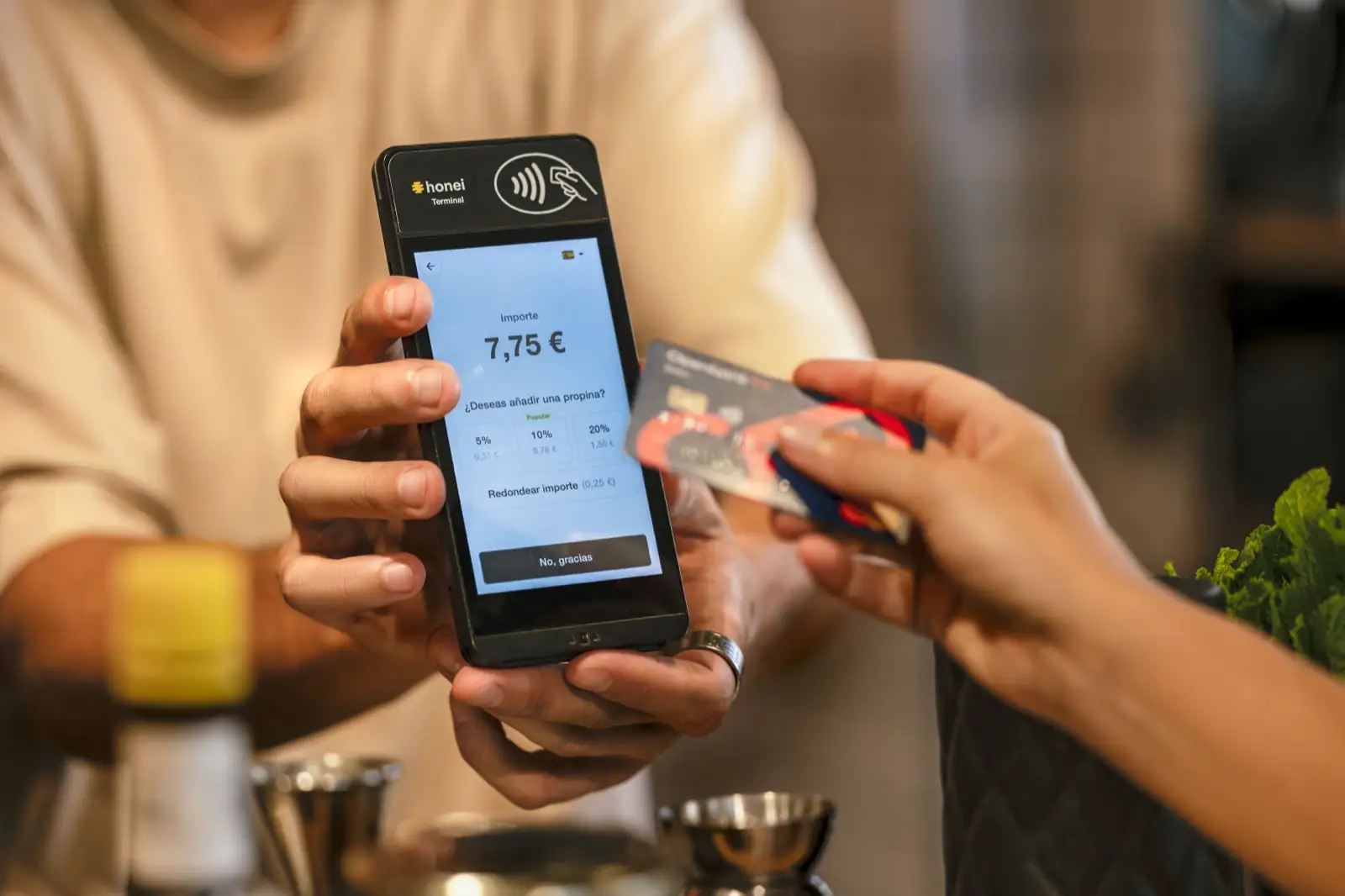 Una clienta paga con tarjeta en el honei Terminal